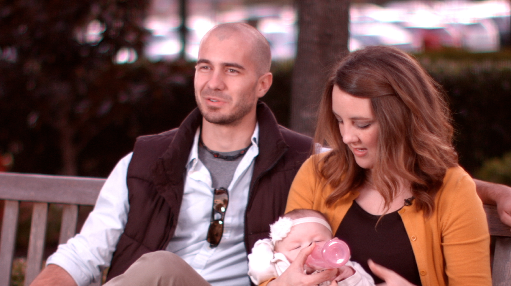 A Couple looking at their baby in a screenshot of the Baptist Health Corporation Video produced by Light Productions